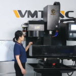 Vertical CNC Milling Machine with a woman standing nearby