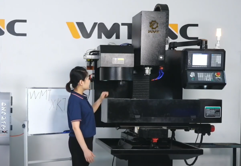 Vertical CNC Milling Machine with a woman standing nearby