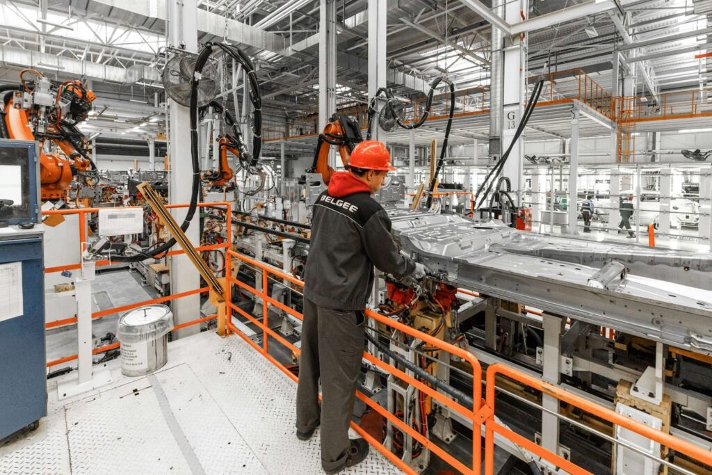 A man in a helmet working on the assembly line