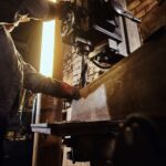 A man works at a lathe