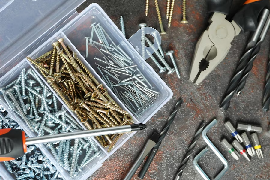 Scattered nails and hardware items