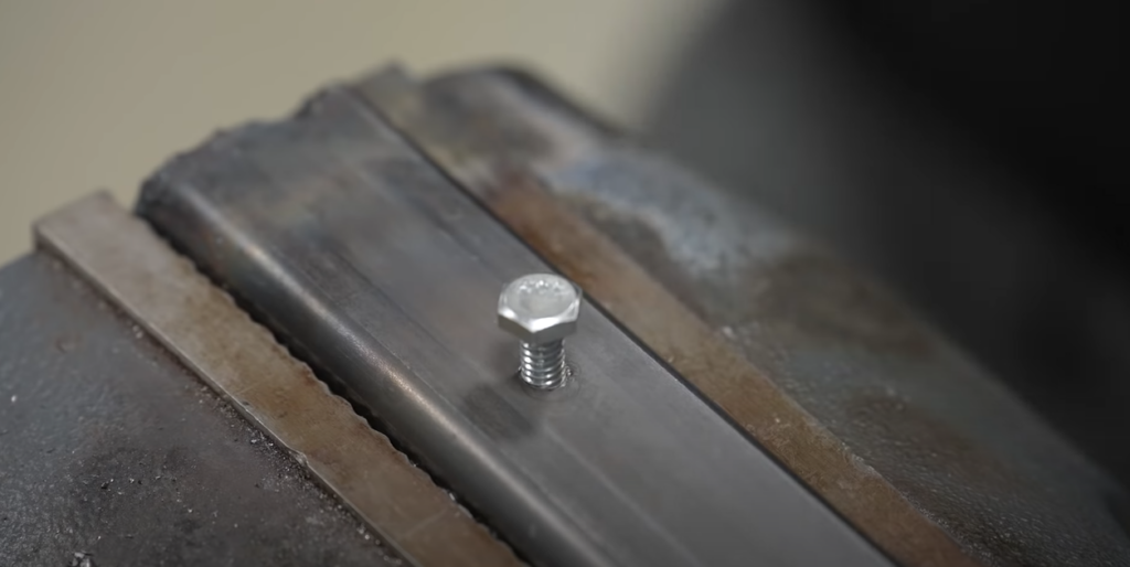 silver nail on metallic surface