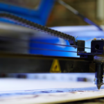 cnc machine drawing a picture and blue light behind