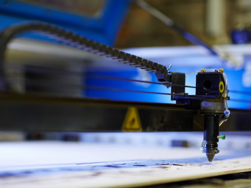 cnc machine drawing a picture and blue light behind