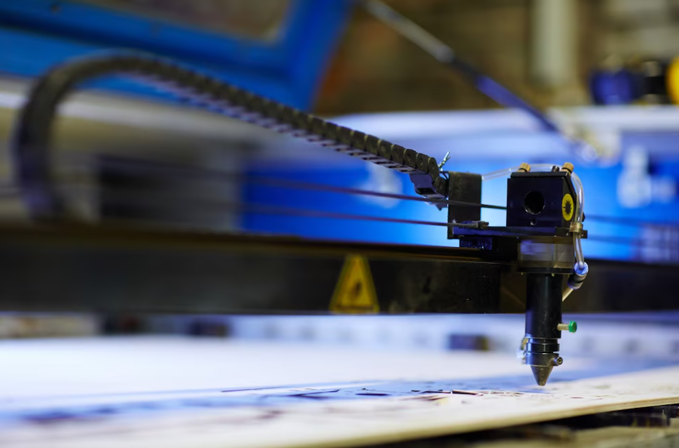 cnc machine drawing a picture and blue light behind